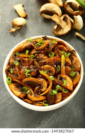 Bowl of roasted mushrooms with exotic spices, Famous Indian vegetarian curry recipes,