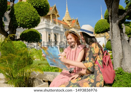 tourist women in exciting discuss find location in map guide information to visit the palace temple in Bangkok of Thailand, Emerald Buddha Temple, Wat Phra Kaew, the Royal Palace popular tourist place