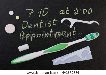 Oral care products on black background. Dental care accessories to remind dentist appointment day.