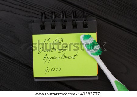 Dental hygiene appointment reminder. Message with date and toothbrush to remind dentist appointment.