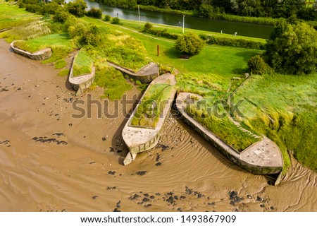Aerial drone view of silt filled hulks of abandoned boats used to reduce erosion on the banks of the River Severn in England (Purton Hulks) Royalty-Free Stock Photo #1493867909