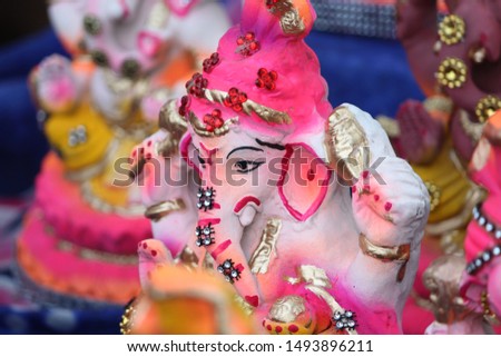 A Beautiful clay statue/Idol of an Indian god Lord Ganesha decorated with multi colors