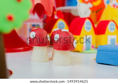 Colorful decor of a mushroom with a red roof. Fairy tale. Snow White and The Seven Dwarfs Children's Party. Decoration of children's party of girl, background for various uses.