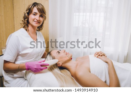 Face massage. Close-up of young woman getting spa massage treatment at beauty spa salon.Spa skin and body care. Facial beauty treatment.Cosmetology. 