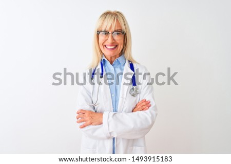 Middle age doctor woman wearing glasses and stethoscope over isolated white background happy face smiling with crossed arms looking at the camera. Positive person.