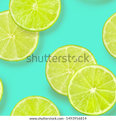 A seamless pattern of lime slices on a vibrant teal blue background, a fruity citrus repeat print