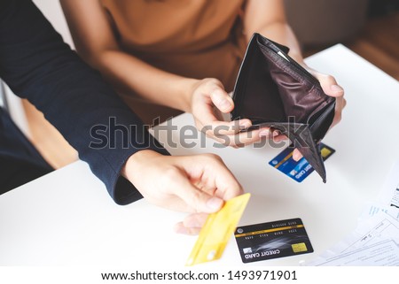 A close-up picture of a wallet without money. Financial and credit problems.
