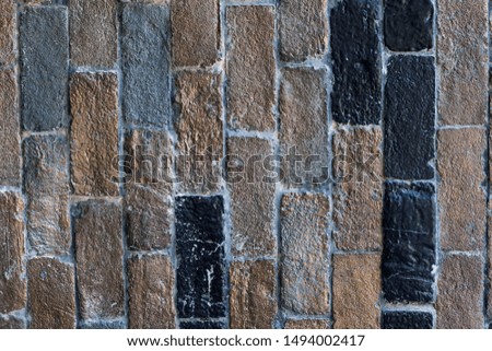 Black and brown tone brick wall. Construction material texture.