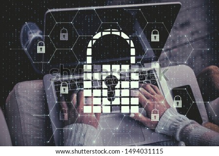 Close up of hands using laptop with creative glowing digital padlock interface on blurry background with icons. Safety and protection concept. Multiexposure