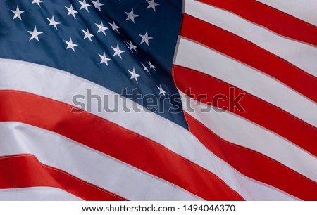Closeup of ruffled American flag waving in the wind