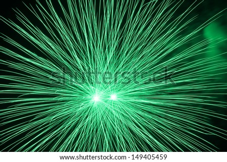 Green fireworks in the night sky 