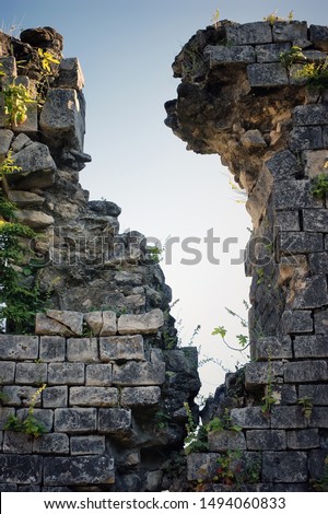 Ruins. The ruins of an old wall. Break in the old brickwork. Royalty-Free Stock Photo #1494060833