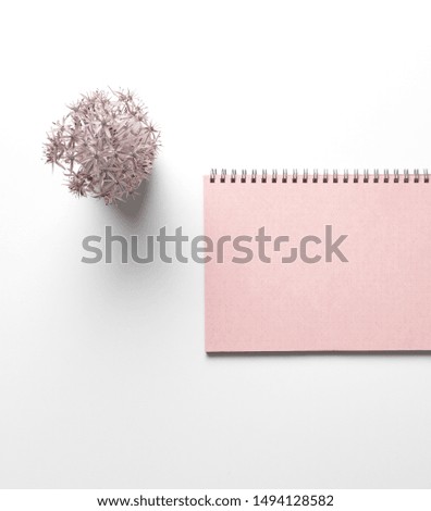 blank notebook with rose pink papers and flower vase on white desk table in Top view, Misty Tea rose color, copy space, Mockup