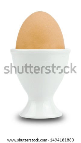 Egg standing on egg cup Isolated on White Background