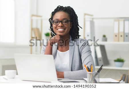 Successful Businesswoman. Afro Girl Sitting At Laptop And Smiling In Modern Office. Empty Space For Text Royalty-Free Stock Photo #1494190352