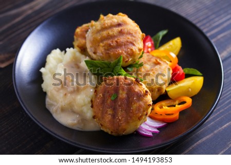 Fish cakes with mashed potatoes and vegetables. Fish patties. Fried cutlets of minced fish