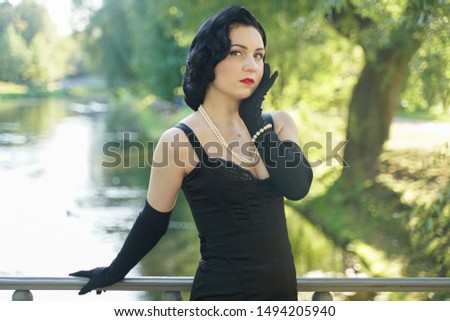 pretty lovely young brunette slim girl in vintage dress on the bridge