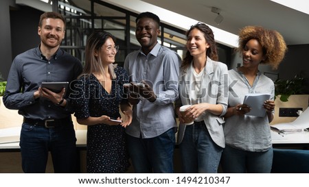 Cheerful happy multicultural business team people laughing joking having fun standing together in modern office friendly positive multiracial colleagues employees good relations lifestyle communicate Royalty-Free Stock Photo #1494210347