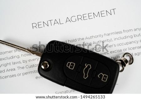 Car key on a rental agreement ready to be signed