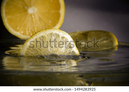 a slice of lemon falls into the water
