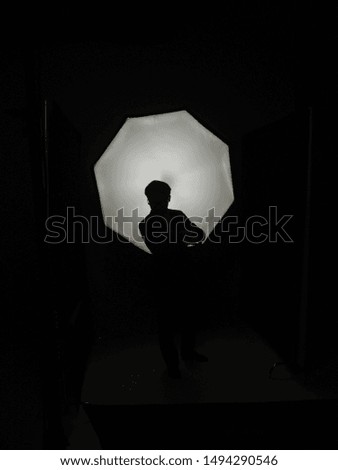 Blackout studio photoshoot of a business person. 
