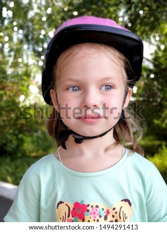 portrait of little girls in a protective helmet for roller skating