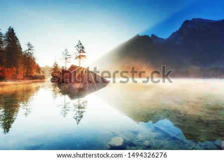 Lake Hintersee in Germany, Bavaria, National Park Ramsau in Alps. Beautiful autumnal Alpine landscape, amazing light during sunrise. Incredible seasonal autumn scenery. Famous landmark in Germany.