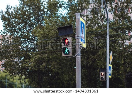 Confusing set of traffic lights showing red and green at the same time on summer road.