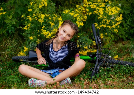 happy girl with a bike outdoors