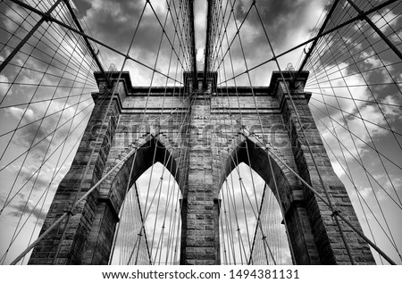 Scenic view of the architectural details of the Brooklyn Bridge in New York City in dramatic black and white monochrome under moody overcast skies Royalty-Free Stock Photo #1494381131