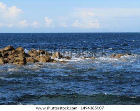 Beach rocks blue open water 