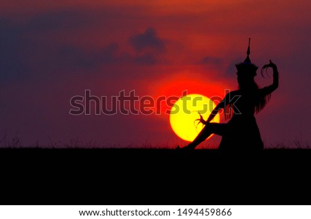 The silhouette of a Thai woman dancing with the sunset or Manohra Thai, Thai art and culture