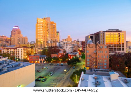 Historic Building on E Commerce St with Weston Centre and Nix Professional Building at the background at sunrise in downtown San Antonio, Texas, USA.