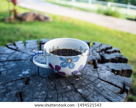 Fresh coffee without sugar or cream is black coffee, drink in the morning, put in a flower-shaped ear cup, drink daily in the morning, drink outside the room in the garden, good weather.