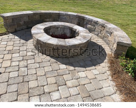 Backyard paver patio with stones and fire place Royalty-Free Stock Photo #1494538685