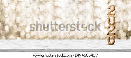 Happy New Year 2020 wood with sparkling star on marble table with gold bokeh background,Holiday festive celebration concept.Banner mock up for display of product or design content Royalty-Free Stock Photo #1494605459