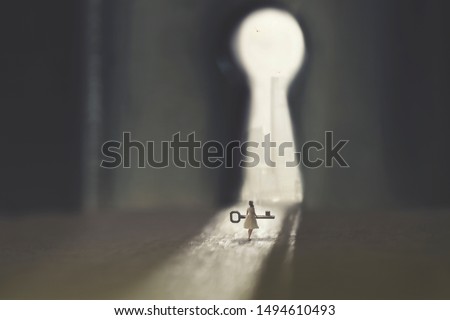 small woman carries the key to open the lock Royalty-Free Stock Photo #1494610493