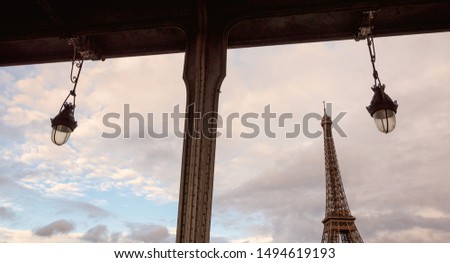 Paris, France. Eiffel tower seen through frame of Bir-Hakeim bridge. Emblematic cityscape background. Parisian tourist attraction. 