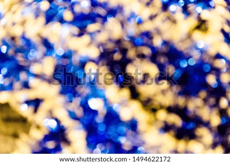 pictured in the photoBlue tinsel Christmas new year sparkles macro blur background