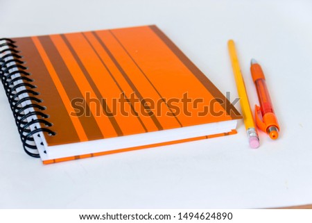 pictured in the photo fountain and pens and notebook on white background