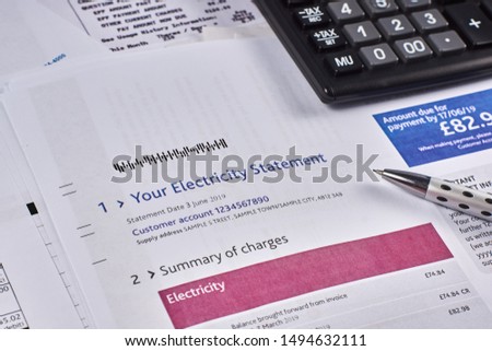 Electricity statement sheet with calculator and pen. Close-up Royalty-Free Stock Photo #1494632111