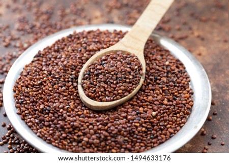 Quinoa seeds of red quinoa - Chenopodium quinoa, in plate and spoon  