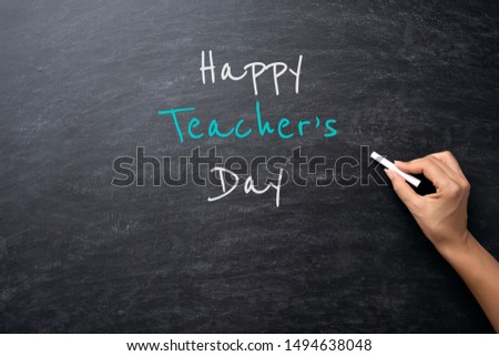 Education or back to school Concept. Woman hand holding chalk with Happy Teacher's Day text over chalkboard background. Royalty-Free Stock Photo #1494638048