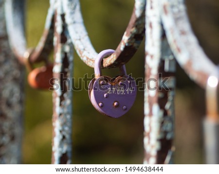 love lock or padlock attached to a bridge or fence. Symbol of unbreakable love and lifetime commitment. Lover's locks