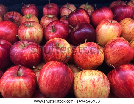 Pile of apples fresh red color, group of apple arranged in horizontal lines, good for background promotes foods, healthy fruits, clean food, healthy foods, women health, beauty tricks tips.