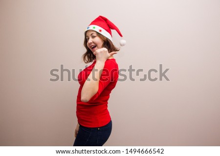  happy girl in santa hat in red blouse on white background 

