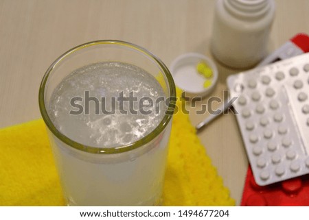 Dissolving tablets in a glass with water.