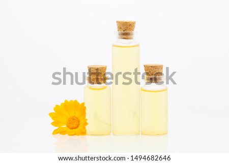 Essence of flowers on White background in a  beautiful glass bottle
