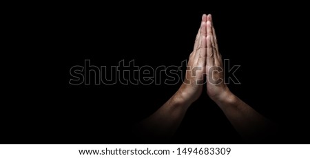 Man hands in praying position low key image. High Contrast isolated  on Black Background. Banner