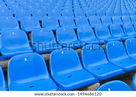 Blue plastic chairs. Empty stadium seats